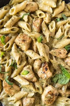 pasta with chicken and pesto sauce in a skillet