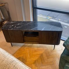 a black marble top entertainment center in a living room