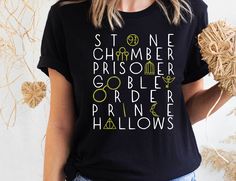 a woman wearing a black tshirt with the words harry potter printed on it