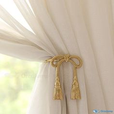 a curtain with gold tassels hanging from it