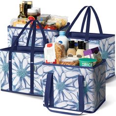 two blue and white bags with food in them sitting side by side on top of each other