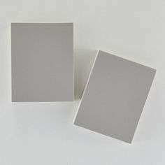 two square white cards sitting next to each other