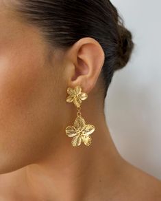 18K Gold Plated Flower Dangle Earrings | Waterproof, Lightweight, Perfect Gift for Her Add a touch of elegance to your jewellery collection with these stunning 18K Gold Plated Flower Dangle Earrings. These earrings are a perfect statement piece combining style and durability. Crafted from high-quality stainless steel with 18K PVD gold plating, they are waterproof and tarnish free. Dimensions: Width: 3 cm Length: 6 cm Weight: 13.3 g Material - Stainless Steel and 18K Gold Plating. Looking for the Flower-shaped Bridal Earrings With Flower Charm, Gold Plated Drop Flower Earrings, Tarnish Resistant Gold Flower Earrings, Flower Dangle Earrings, Flower Drop Earrings, Earrings Flower, Flower Plates, Gold Earrings Dangle, Etsy Earrings Dangle