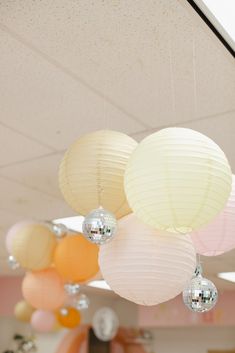 some white and pink lanterns hanging from the ceiling