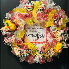 a yellow and red mesh wreath with some lemons on it that says, we're life gives you lemons don't some crawfish