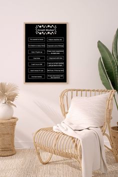 a room with a wicker chair, potted plant and blackboard on the wall