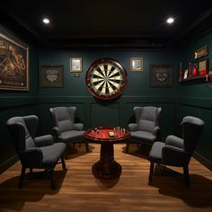 a room with chairs and darts in the center, surrounded by pictures on the wall