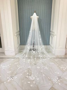 a white wedding dress on display in a room