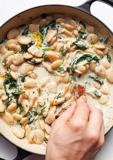 a person is cooking some food in a skillet