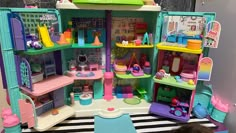 a child is playing with a doll house