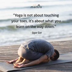 a man is doing yoga on the beach with a quote above him that reads, yoga is not about touching your toes, it's about what you learn on the way down