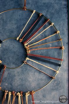 a circle made out of sticks with tassels