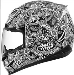 a motorcycle helmet with an intricate design on the front and side, all in black and white