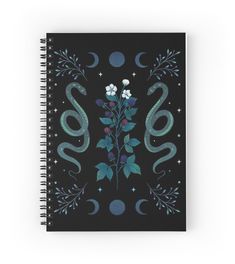 a spiral notebook with an image of flowers and snakes on the cover, surrounded by stars