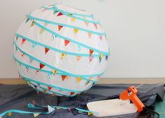 a hot air balloon sitting on top of a table next to scissors and other items