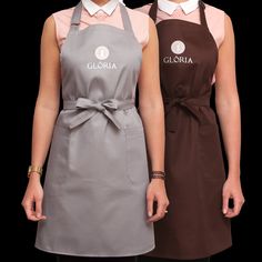 two women standing next to each other wearing aprons with the words glorsia on them