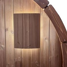 a close up of a wooden structure with a light on it's side and wood paneling