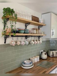 a kitchen counter with dishes and cups on it