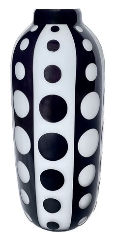 a black and white vase with dots on it