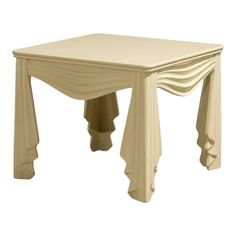 a white table with an unusual design on it's top and legs, sitting against a white background