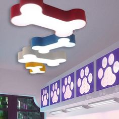 the lights are hanging from the ceiling in the room with many paw prints on it