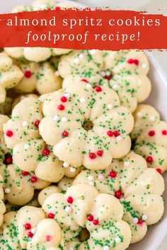 a plate full of almond spritz cookies with red and green sprinkles