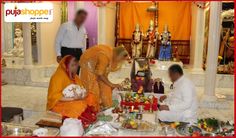 men and women sitting around a small shrine