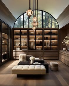 a living room filled with lots of furniture and shelves covered in glass doors next to a wooden floor