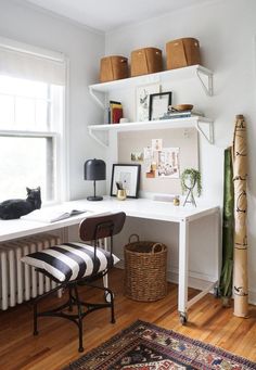 a white desk with black and white striped chair