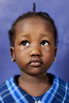 a close up of a child's face with an odd look on her face