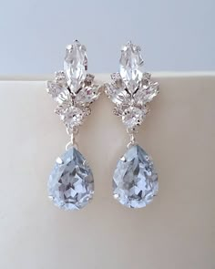 "A classic statement, these lovely earrings will certainly make you unforgettable on your big day or any available other occasion. ✤ I can make these earrings with many available other colors to match your wedding party scheme (or any available other occasion). Please just contact me. They are made of silver plated brass and European crystals, all set in prong setting. Made with premium quality genuine European crystals. ✤ Matching bracelet is available here: https://etsy.me/2vTx0TG ✤ Stud/post Blue Bridal Earrings, Blue Chandelier, Bridal Earrings Chandelier, Aquamarine Earrings, Blue Bridal, Swarovski Earrings, Fantasy Jewelry, Lovely Earrings, Girly Jewelry