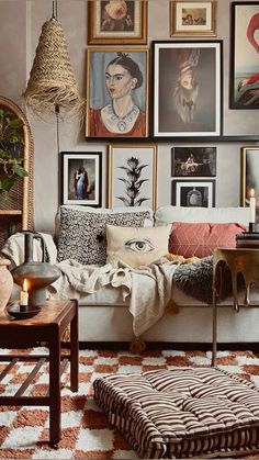 a living room filled with lots of pictures on the wall and furniture in front of it