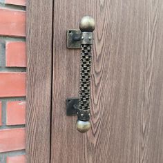 a close up of a door handle on a wooden door