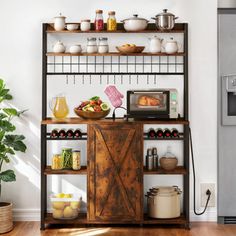 a kitchen with an oven, microwave and shelves filled with food on top of it