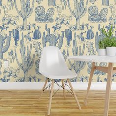 a table and chair in front of a cactus wallpaper