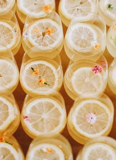 several slices of lemons with flowers on them are arranged in the shape of circles