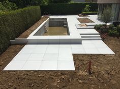 an outdoor kitchen is being built in the middle of a yard with landscaping around it