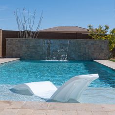 a large white sculpture sitting in the middle of a pool