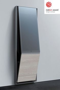 a modern wooden and glass cabinet against a wall with the red dot award logo on it