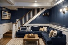 a living room with blue walls and white trim