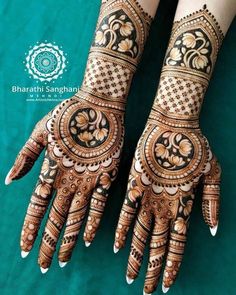 two hands with henna designs on them