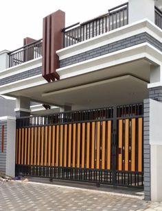 a house that has been fenced in with wooden slats on the front and sides