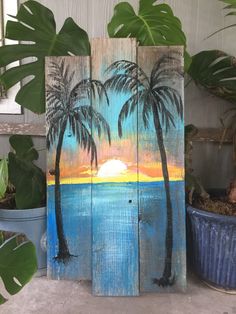 a wooden sign with palm trees painted on it