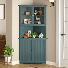 a living room with a blue bookcase next to a brown chair and potted plant