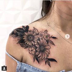 a woman's shoulder with flowers on it