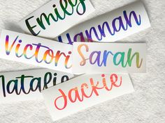 four watercolor name stickers on top of a white surface with the words, names, and colors