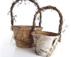 two baskets made out of branches sitting next to each other