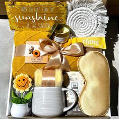 an open box containing items from the sunshine and sunflowers collection, including a coffee mug