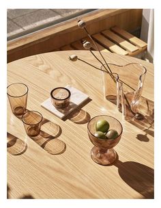 there are three glasses and two olives on the table