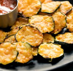 zucchini fritters on a plate with dipping sauce